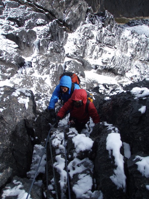 Snow is not uncommon. Here climbers leave the upper face to access the summit ridge proper.
